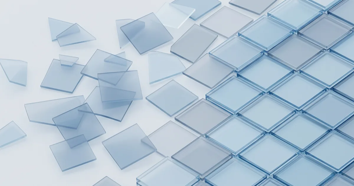 Abstract translucent blue and grey shapes that start as scattered forms and organise into a structured grid pattern.